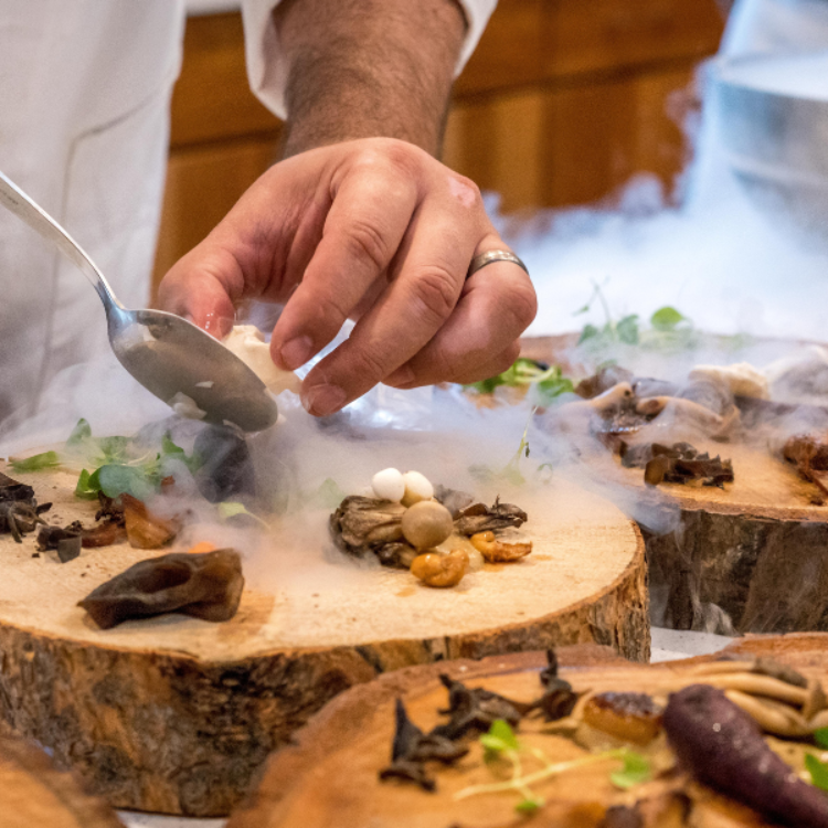 Bustling restaurant interior with wooden ceiling and stone walls, showcasing successful operations developed through Playground Hospitality's restaurant consultant services